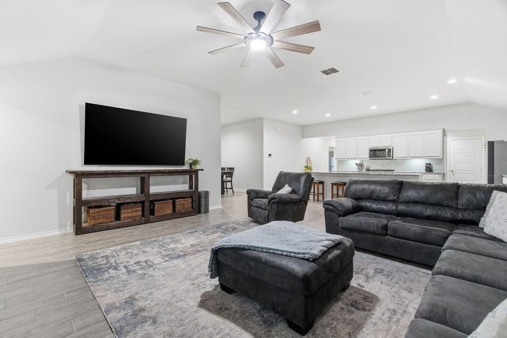 437 Falcon Way Azle, TX 76020 - Photo 9 of 40 a living room with furniture and a flat screen tv