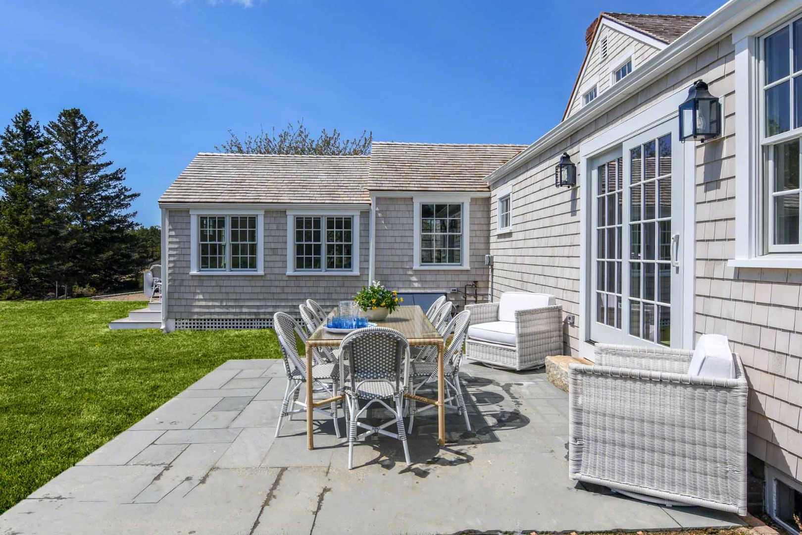 30 Mill Hill Road Edgartown, MA 02539 - Photo 34 of 35 a view of a patio with table and chairs and potted plants