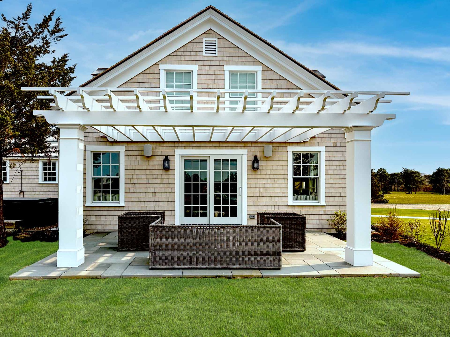 30 Mill Hill Road Edgartown, MA 02539 - Photo 4 of 35 a front view of a house with a yard table and chairs