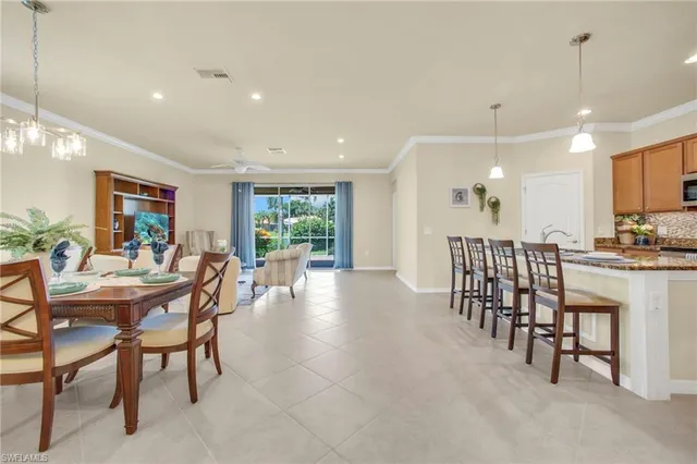 a dining room with furniture and a floor to ceiling window