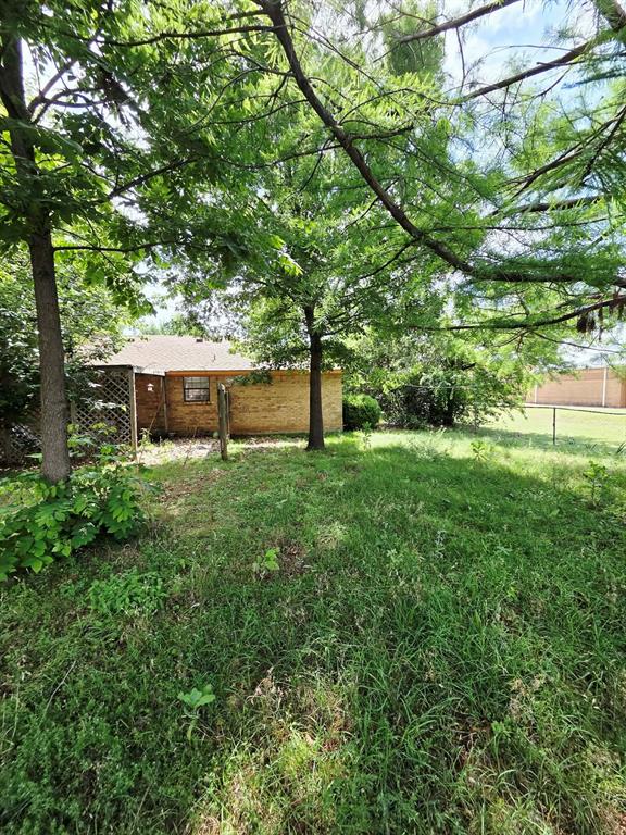722 South Church Street Pilot Point, TX 76258 - Photo 22 of 37 a view of house with a big yard and large trees