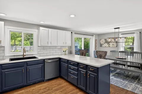 a kitchen with a sink window and cabinets