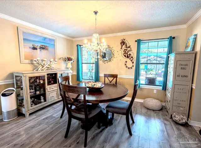 a view of a patio with a table and chairs under an umbrella with a patio