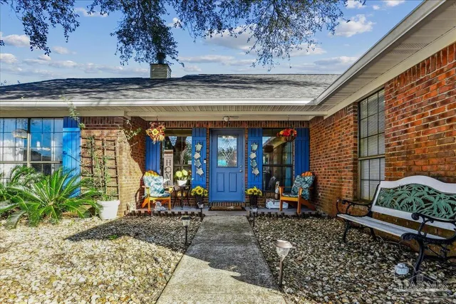 a kitchen with stainless steel appliances granite countertop a stove and white cabinets