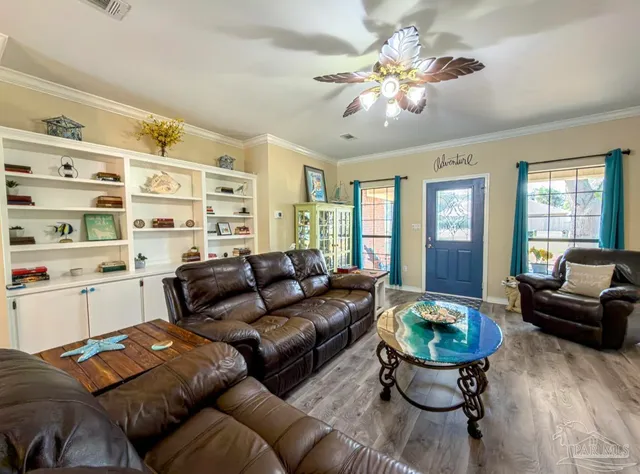 a living room with furniture kitchen view and a refrigerator