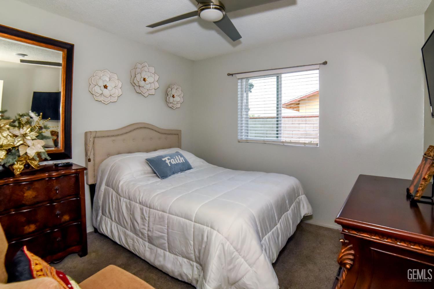 Undisclosed Address Wasco, CA 93280 - Photo 11 of 22 a bedroom with a bed and a window