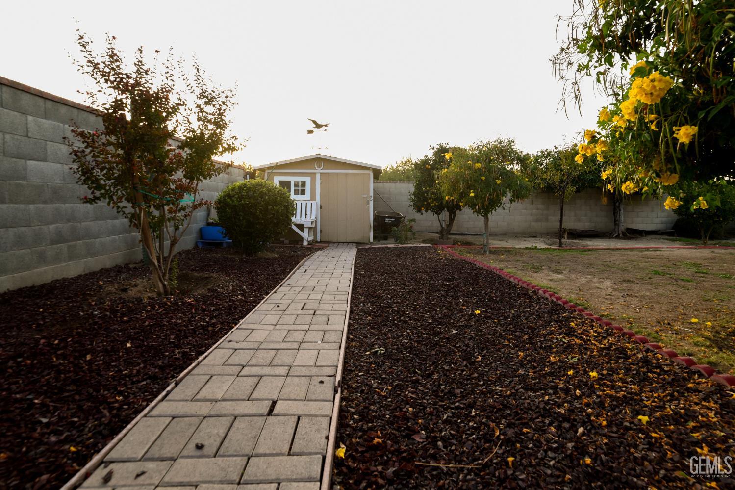 Undisclosed Address Wasco, CA 93280 - Photo 17 of 22 a front view of a house with a yard