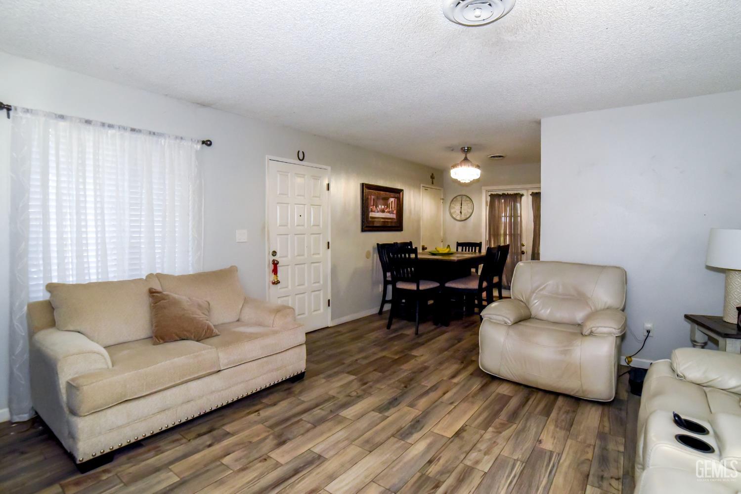 Undisclosed Address Wasco, CA 93280 - Photo 4 of 22 a living room with furniture and a wooden floor