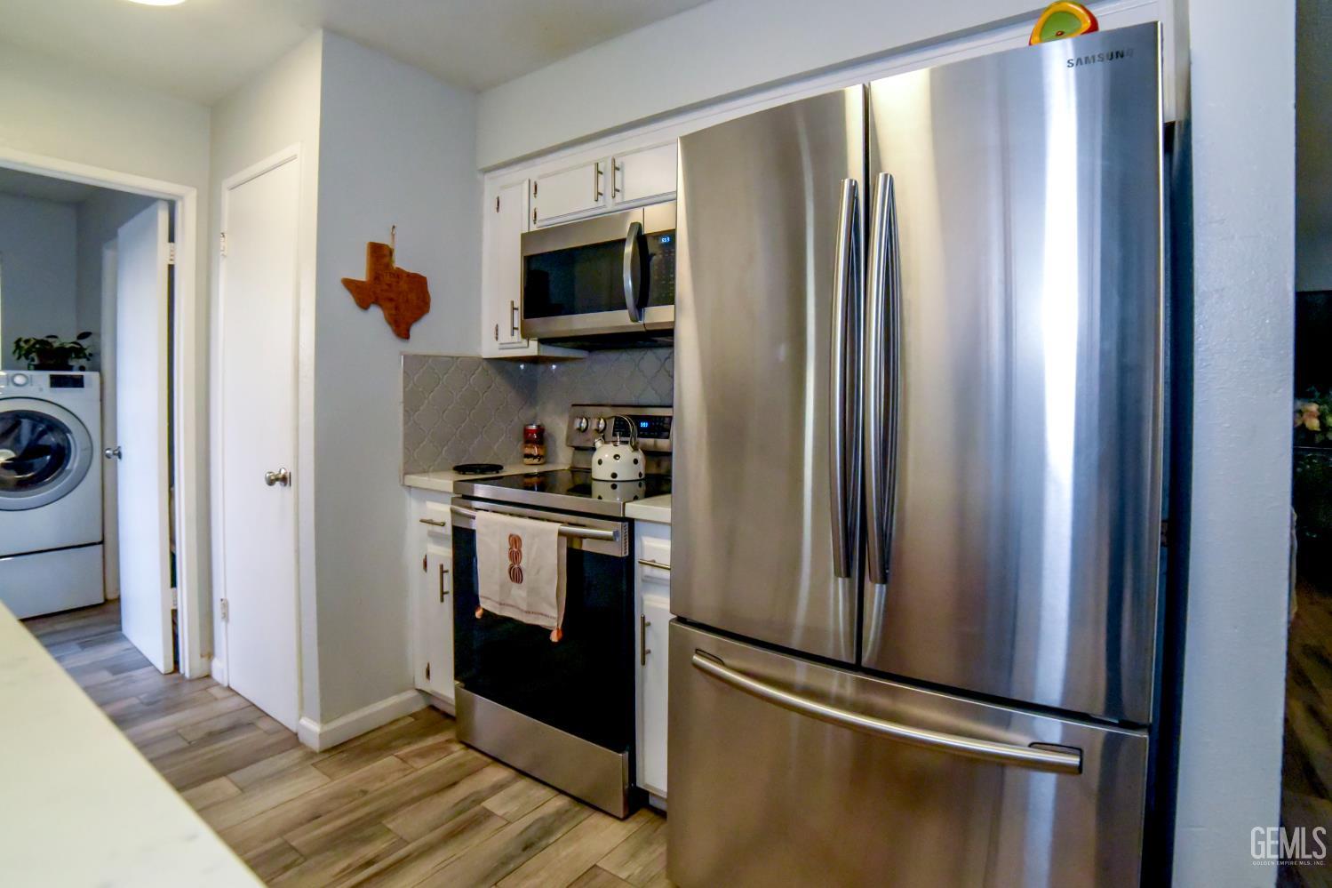 Undisclosed Address Wasco, CA 93280 - Photo 7 of 22 a kitchen with stainless steel appliances granite countertop a refrigerator and a sink