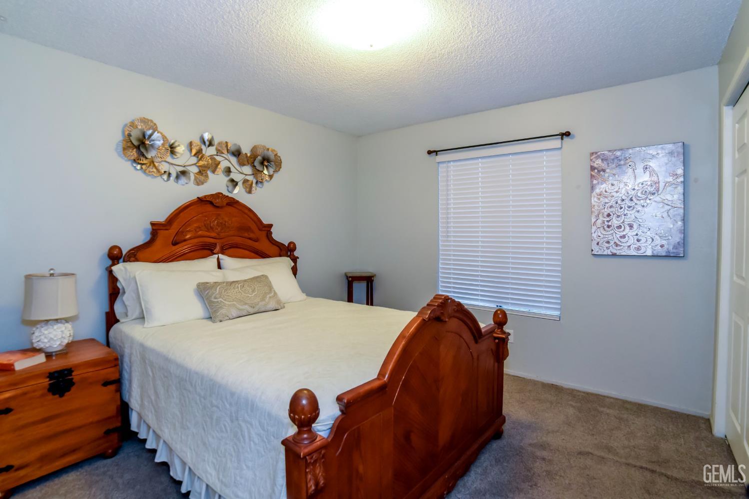 Undisclosed Address Wasco, CA 93280 - Photo 9 of 22 a bedroom with a bed and a potted plant