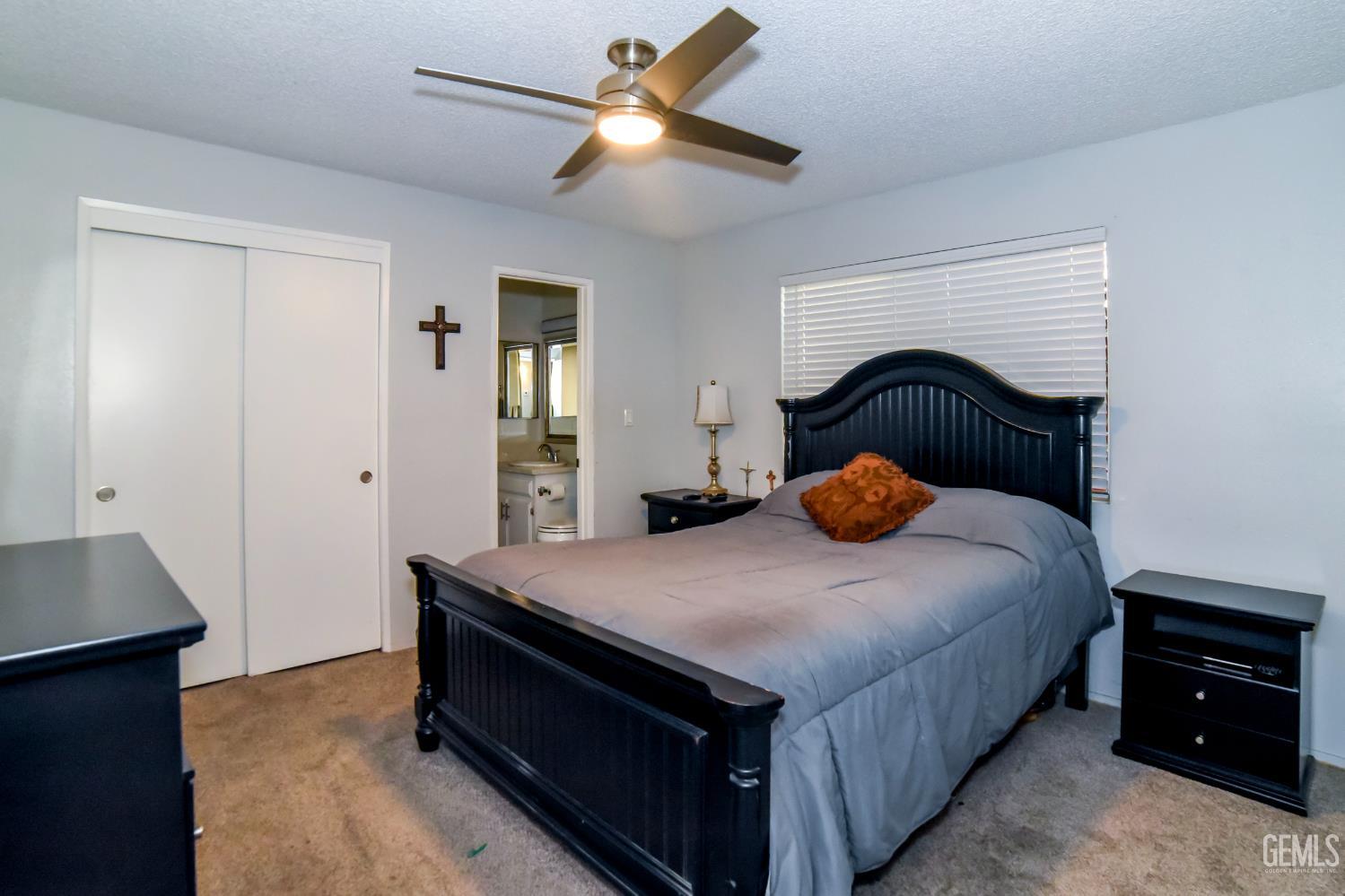 Undisclosed Address Wasco, CA 93280 - Photo 10 of 22 a bedroom with a bed and a chandelier