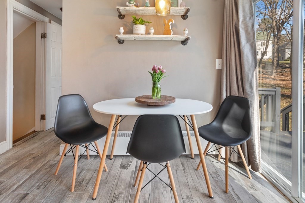 63 Maple Street Middleton, MA 01949 - Photo 11 of 36 a table and a chair with wooden floor next to a window