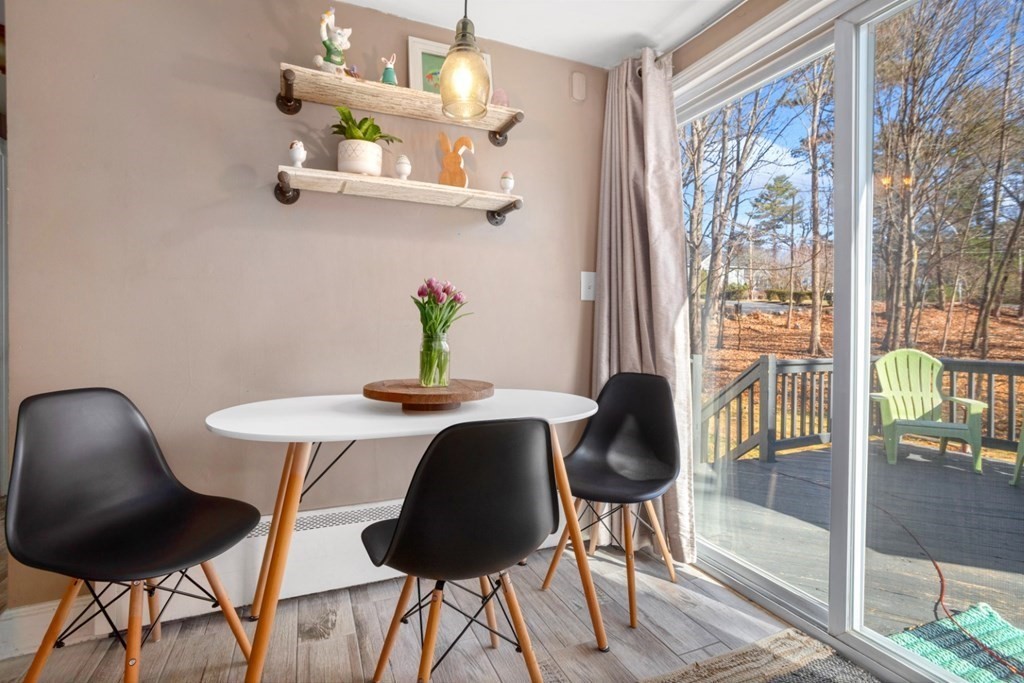 63 Maple Street Middleton, MA 01949 - Photo 12 of 36 a view of a dining room with furniture and a large window