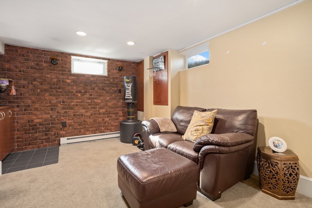 63 Maple Street Middleton, MA 01949 - Photo 24 of 36 a living room with furniture and a brick wall