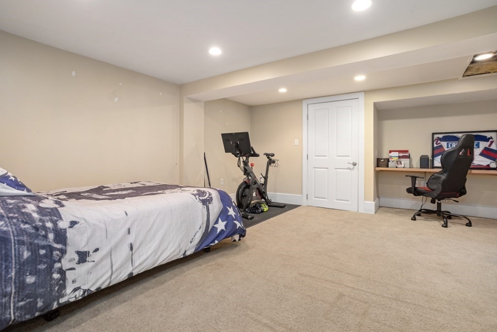 63 Maple Street Middleton, MA 01949 - Photo 27 of 36 a bedroom with a bed and gym equipment