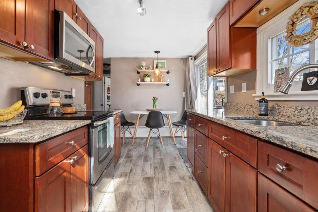 63 Maple Street Middleton, MA 01949 - Photo 6 of 36 a kitchen with granite countertop lots of counter top space and a sink