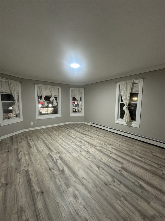 269 South Broadway, Unit 2 Lawrence, MA 01843 - Photo 1 of 12 an empty room with wooden floor and windows