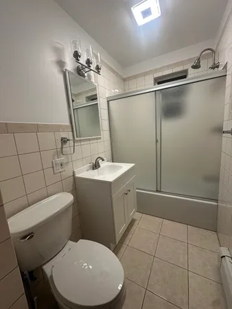 a bathroom with a toilet sink and shower