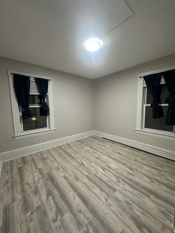 269 South Broadway, Unit 2 Lawrence, MA 01843 - Photo 6 of 12 a view of empty room with wooden floor and fan