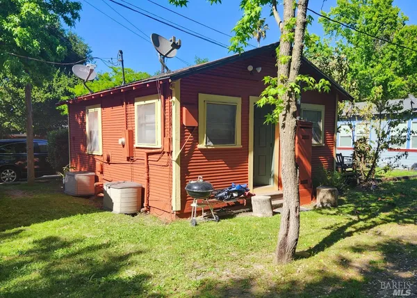 a view of a house with backyard and a patio