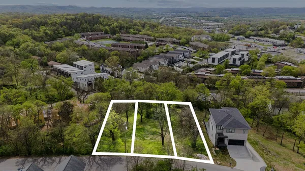 an aerial view of house with a yard