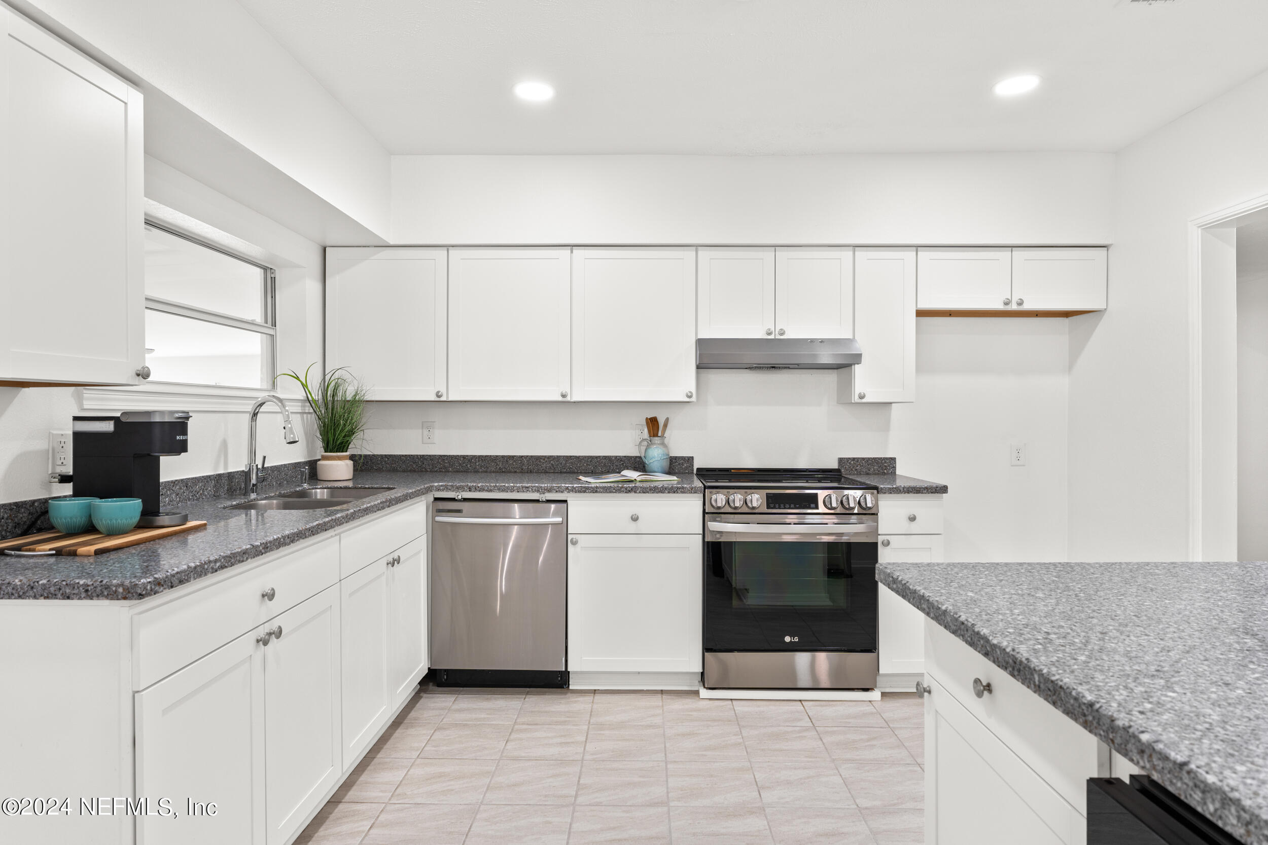 755 Old Hickory Road Jacksonville, FL 32207 - Photo 12 of 30 a kitchen with stainless steel appliances granite countertop a stove sink and cabinets