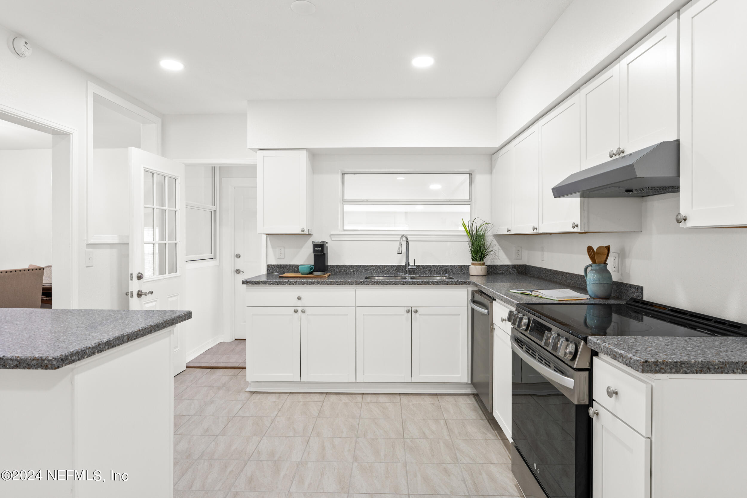 755 Old Hickory Road Jacksonville, FL 32207 - Photo 13 of 30 a kitchen with stainless steel appliances granite countertop a sink stove and cabinets