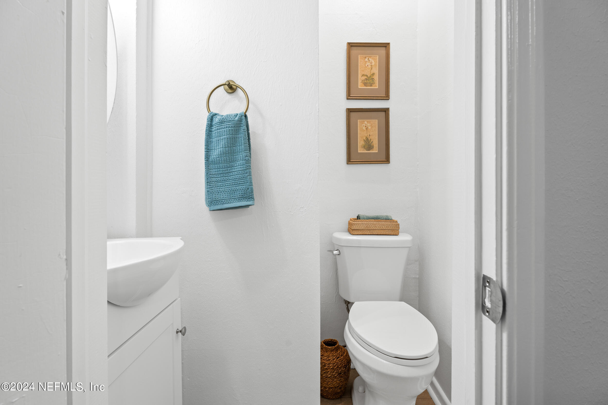 755 Old Hickory Road Jacksonville, FL 32207 - Photo 24 of 30 a white toilet sitting next to a bathroom sink and vanity