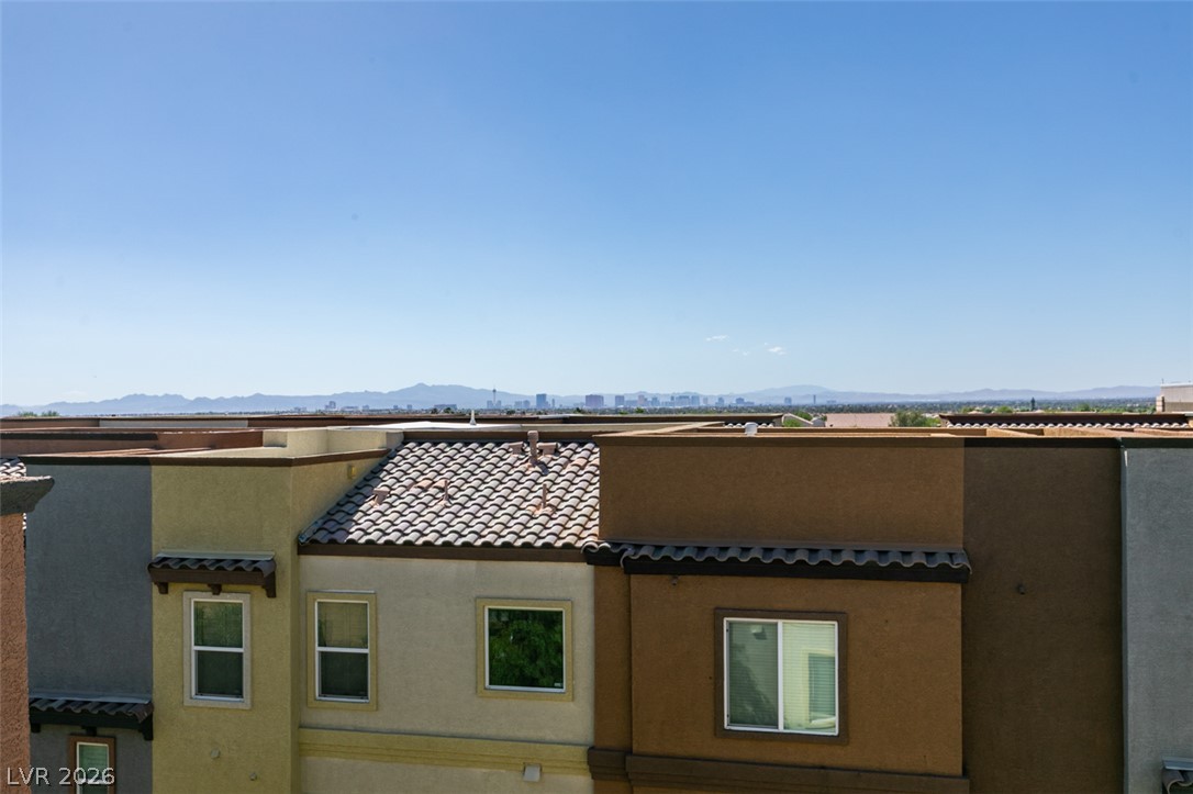 4650 Ranch House Road, Unit 46 North Las Vegas, NV 89031 - Photo 35 of 38 Distant city skyline and mountain views create a scenic backdrop over tiled rooftops.