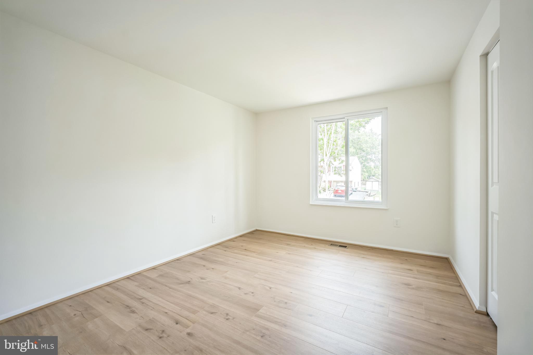 1797 Valleyside Drive Frederick, MD 21702 - Photo 19 of 38 an empty room with wooden floor and windows