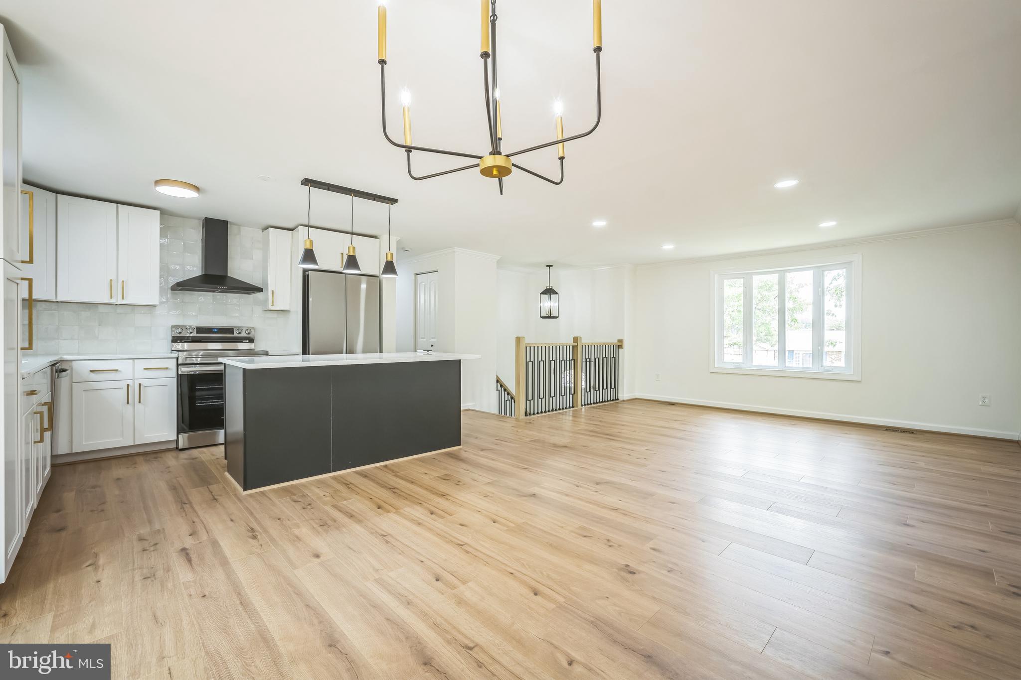 1797 Valleyside Drive Frederick, MD 21702 - Photo 20 of 38 a kitchen with stainless steel appliances granite countertop a sink cabinets and wooden floor