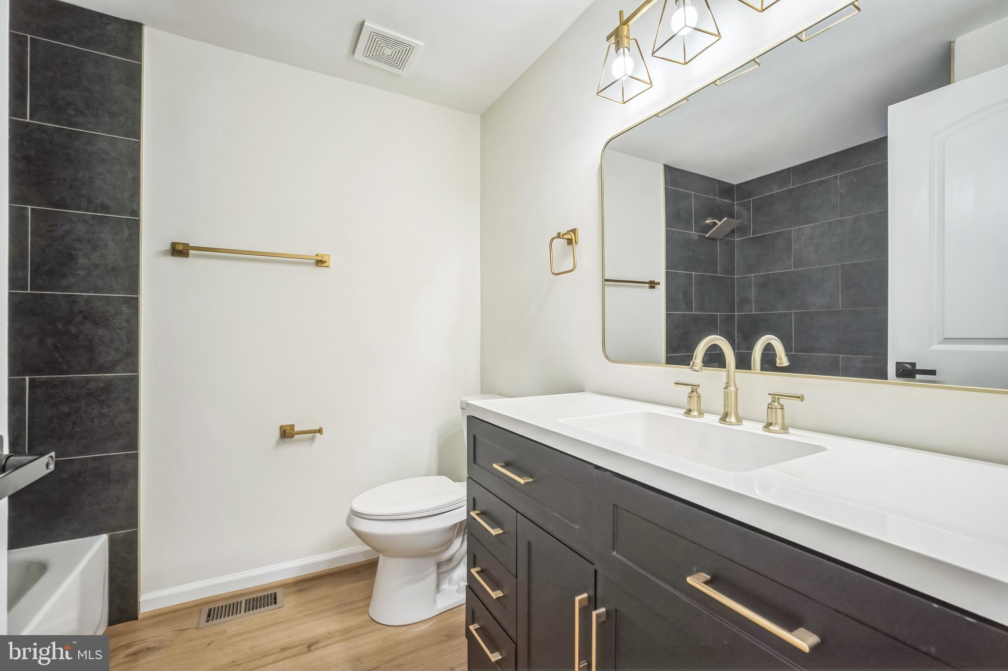 1797 Valleyside Drive Frederick, MD 21702 - Photo 25 of 38 a bathroom with a toilet a sink and mirror