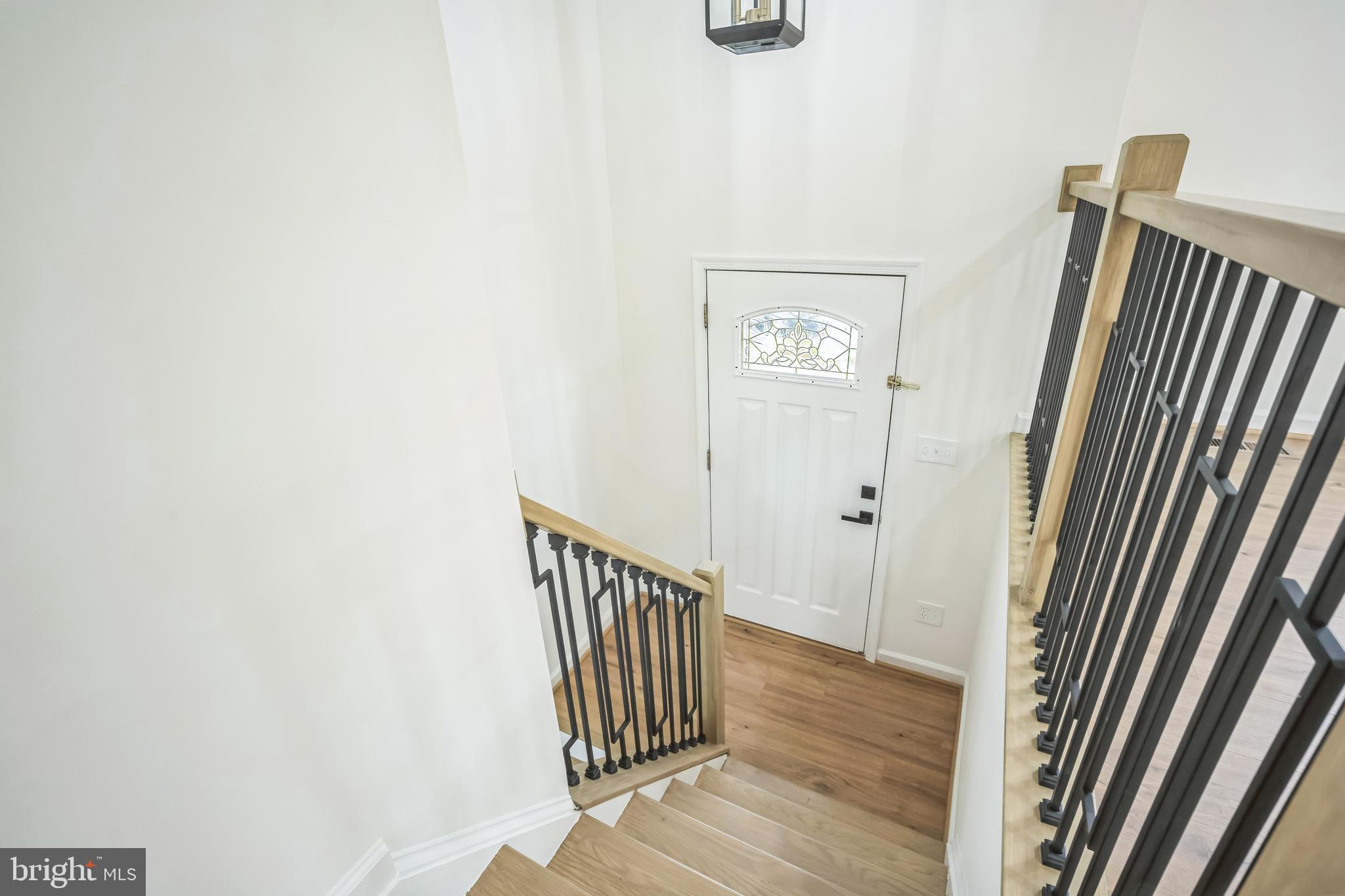 1797 Valleyside Drive Frederick, MD 21702 - Photo 29 of 38 a view of a hallway with wooden floor and staircase