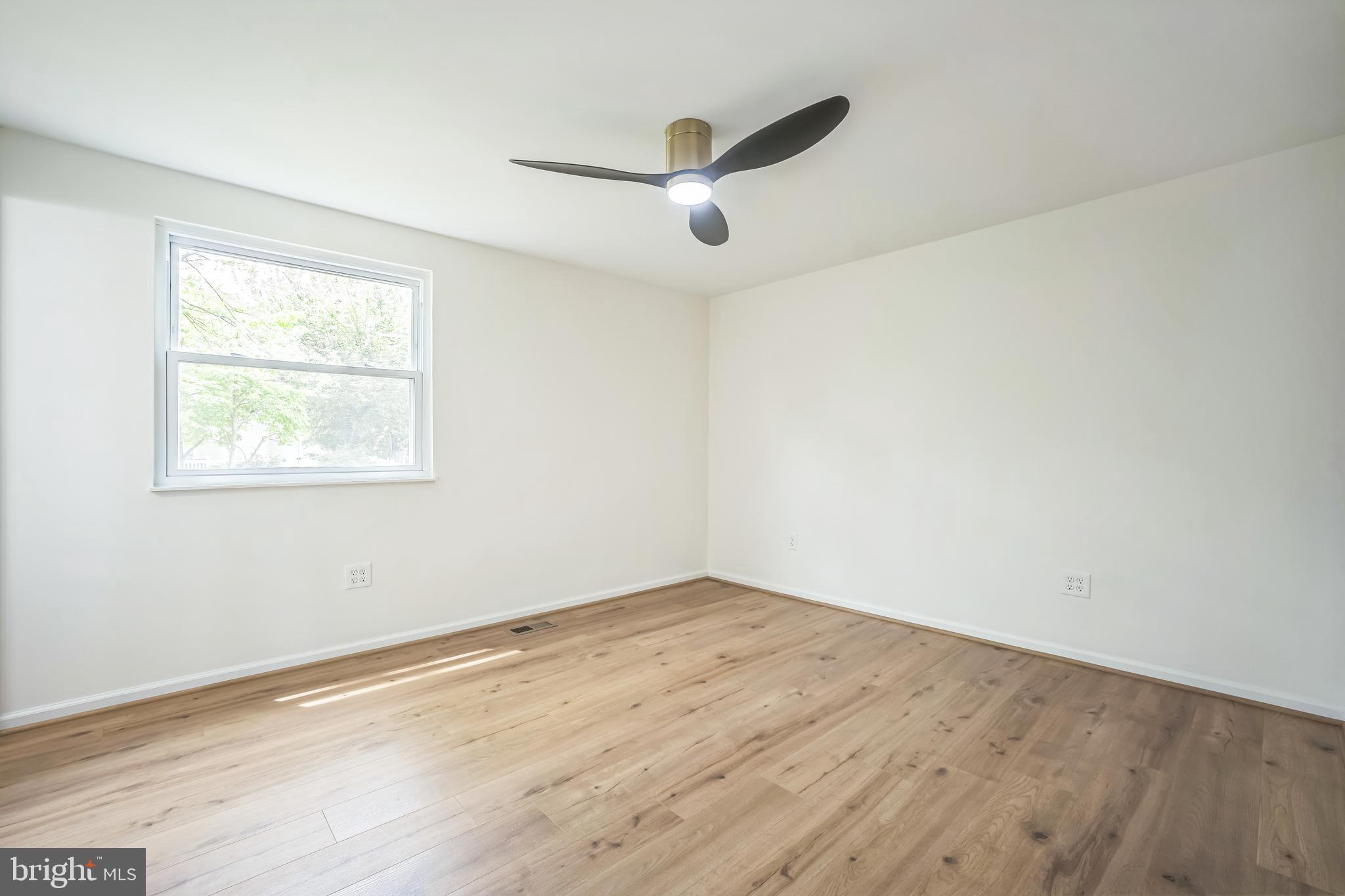 1797 Valleyside Drive Frederick, MD 21702 - Photo 31 of 38 an empty room with wooden floor and windows