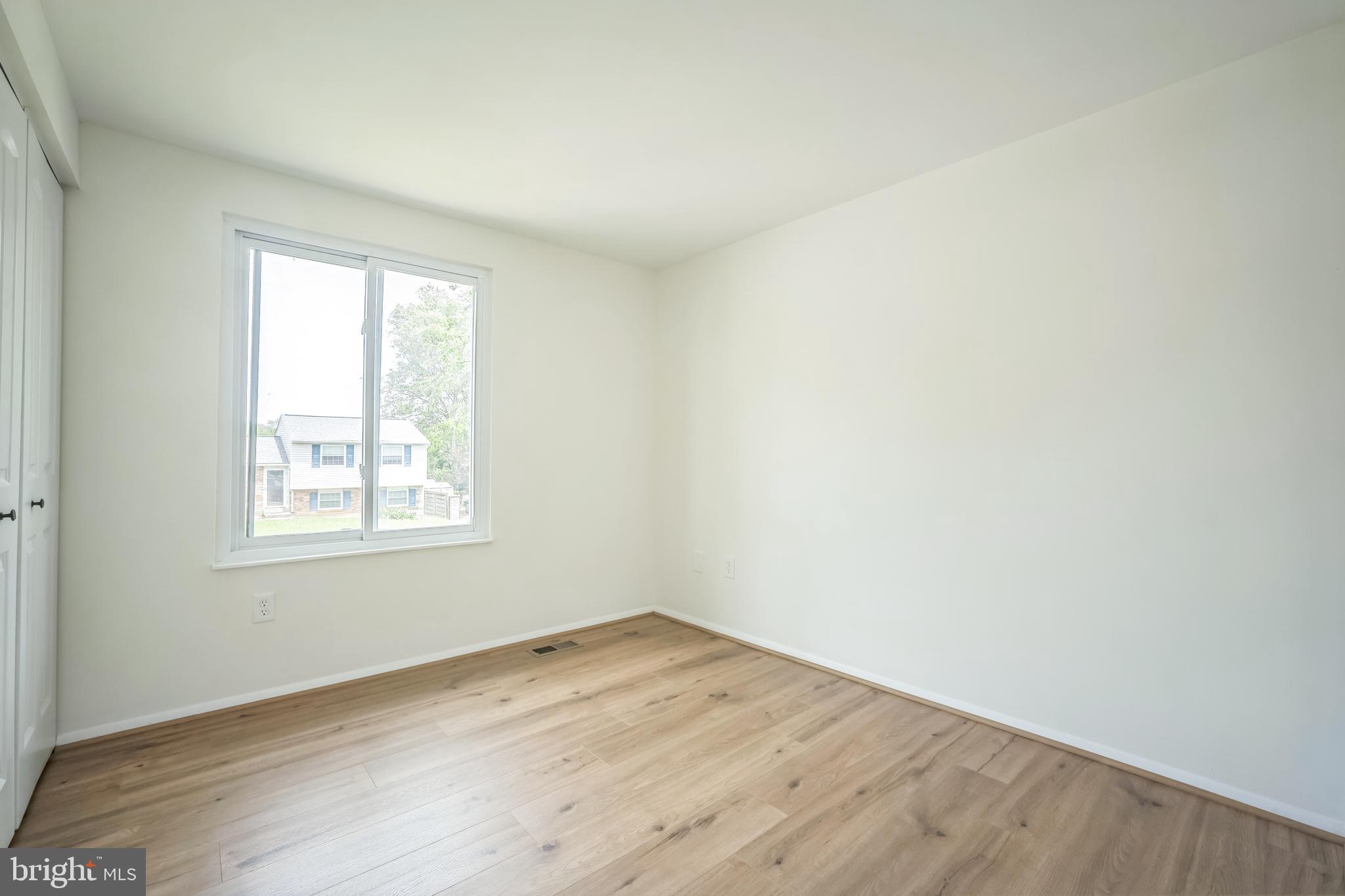 1797 Valleyside Drive Frederick, MD 21702 - Photo 33 of 38 an empty room with wooden floor and windows