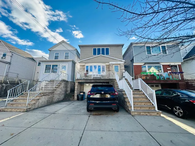 a car parked in front of a brick house