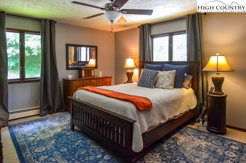 165 Wilson Ridge Road Boone, NC 28607 - Photo 11 of 22 a bed sitting in a bedroom next to a window