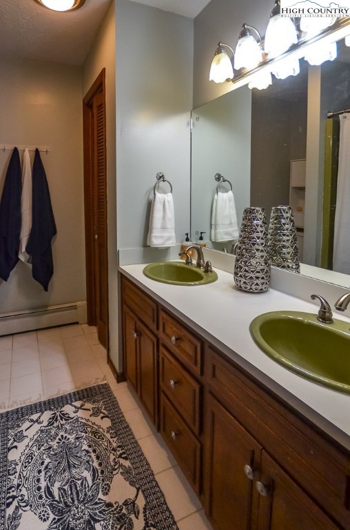 165 Wilson Ridge Road Boone, NC 28607 - Photo 14 of 22 a bathroom with a double vanity sink and a mirror