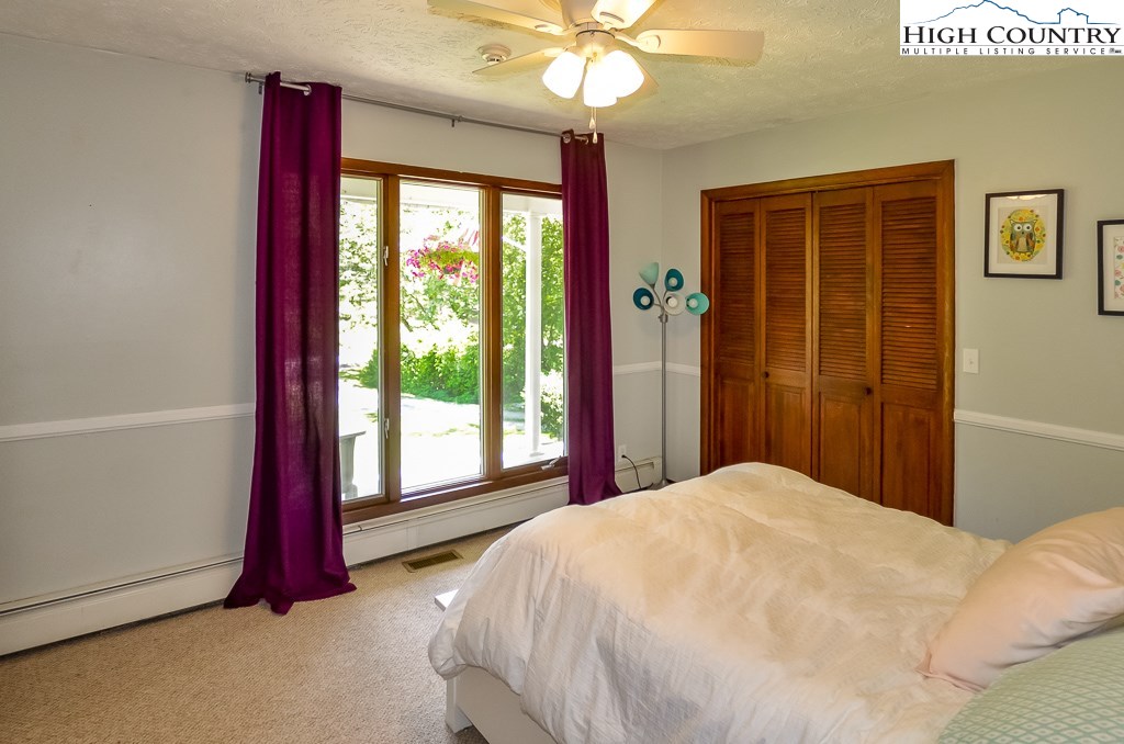 165 Wilson Ridge Road Boone, NC 28607 - Photo 15 of 22 a bedroom with a large bed and a large window