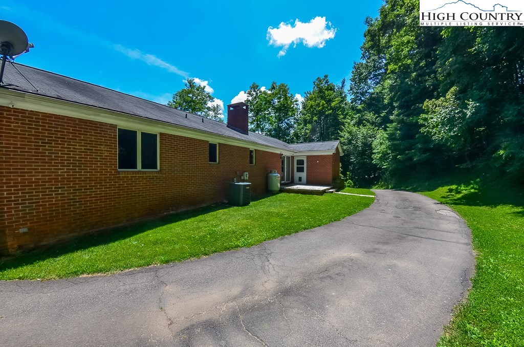 165 Wilson Ridge Road Boone, NC 28607 - Photo 20 of 22 a front view of a house with a yard and garage