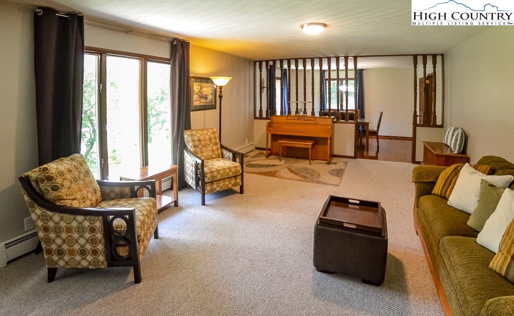 165 Wilson Ridge Road Boone, NC 28607 - Photo 4 of 22 a living room with furniture and large windows