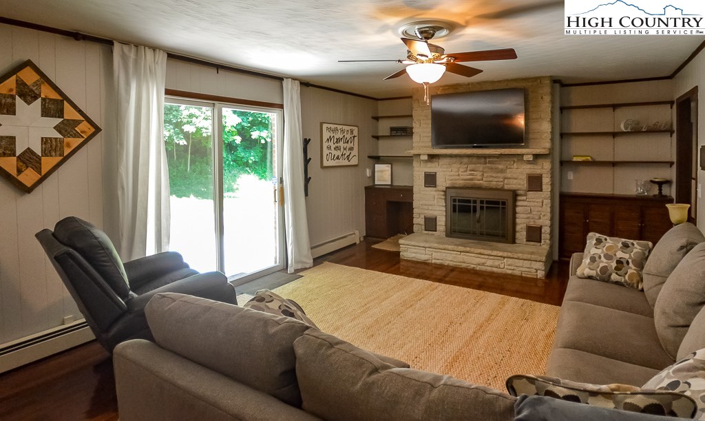 165 Wilson Ridge Road Boone, NC 28607 - Photo 9 of 22 a living room with furniture a flat screen tv and a fireplace