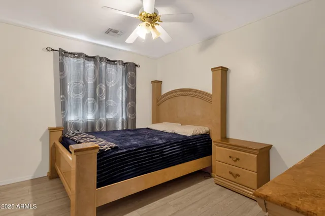 a bedroom with a bed and a dresser