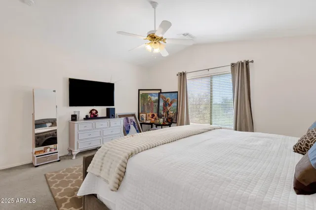 a bedroom with a bed and a flat screen tv