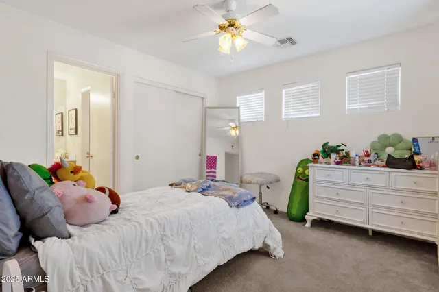a bedroom with a bed and ceiling fan