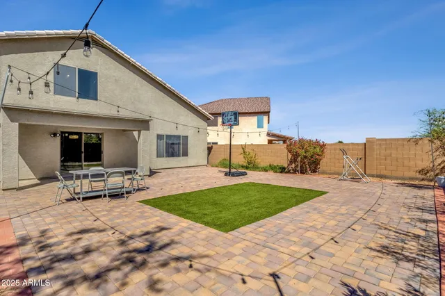 a view of a house with backyard and sitting area
