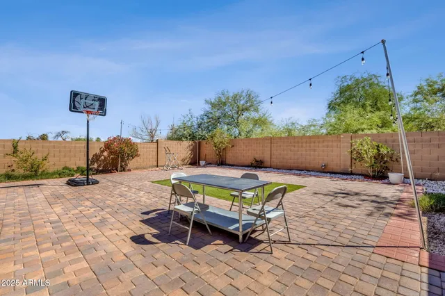 a building outdoor space with patio furniture and potted plants
