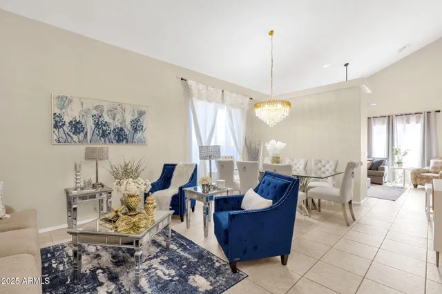 a living room with furniture and a chandelier