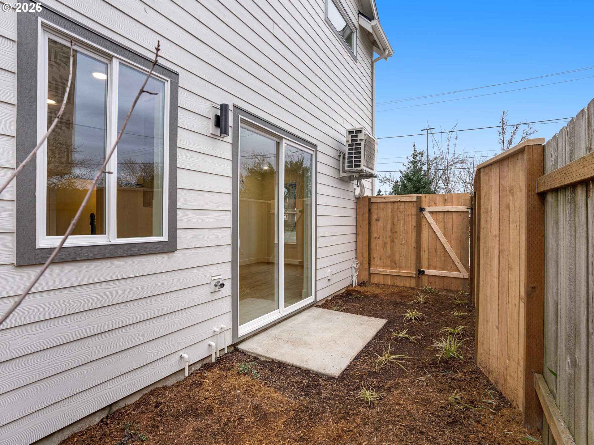 5871 Northeast Prescott Street Portland, OR 97218 - Photo 13 of 25 a view of a house with a door and wooden walls
