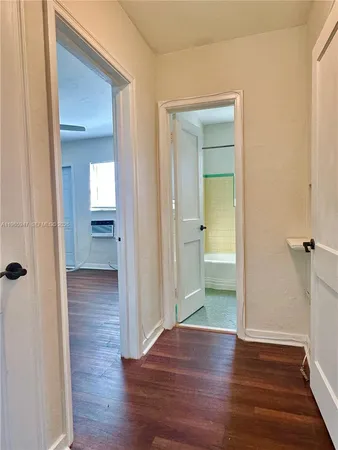 a view of a hallway with wooden floor